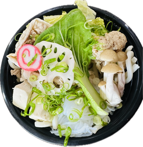 Sukiyaki MicrowavaBOWL from above with udon, tsukune, pork belly, lotus root, kamaboko, shimeji mushrooms, tofu, pak choy, and green onion